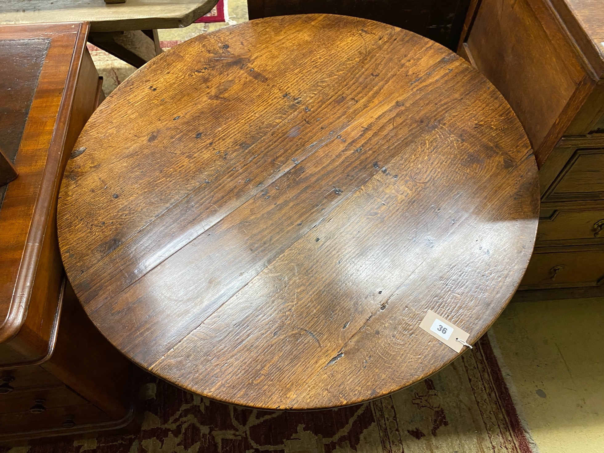 A George III circular oak tilt top birdcage tripod tea table, diameter 89cm, height 71cm